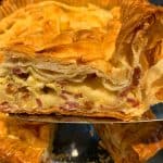 A close-up of a slice of pie being served, showcasing layers of flaky golden-brown pastry filled with creamy cheese and pieces of ham. The rest of the pie is in the background.